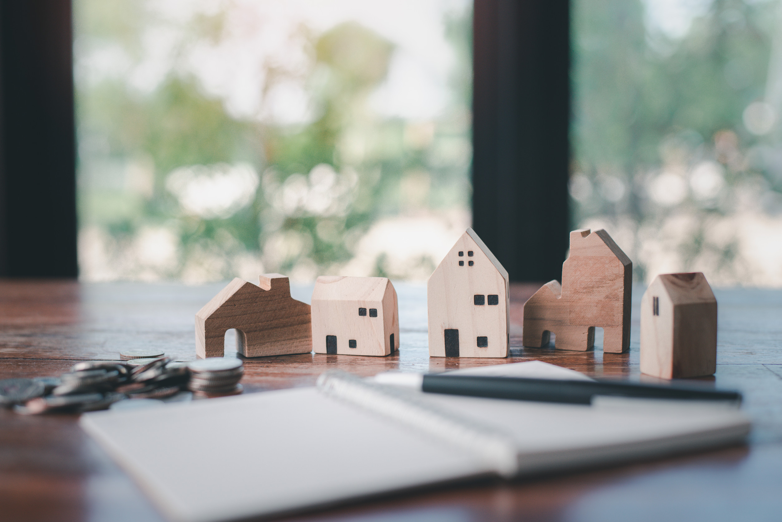 house model with money coins and notebook.house buying planning